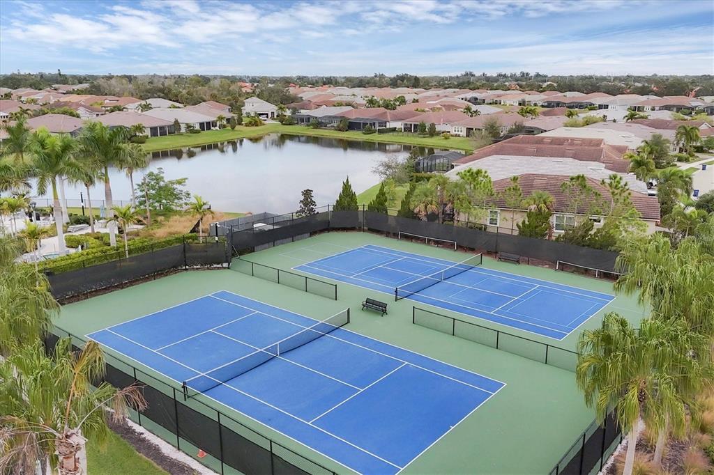 8733 Rain Song Road Sarasota, FL 34238 - Photo 34 of 39 a view of a tennis ground with a lake view