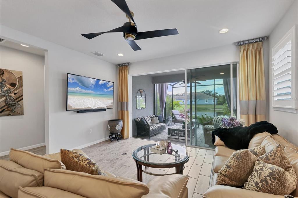 8733 Rain Song Road Sarasota, FL 34238 - Photo 5 of 39 a living room with furniture and a large window