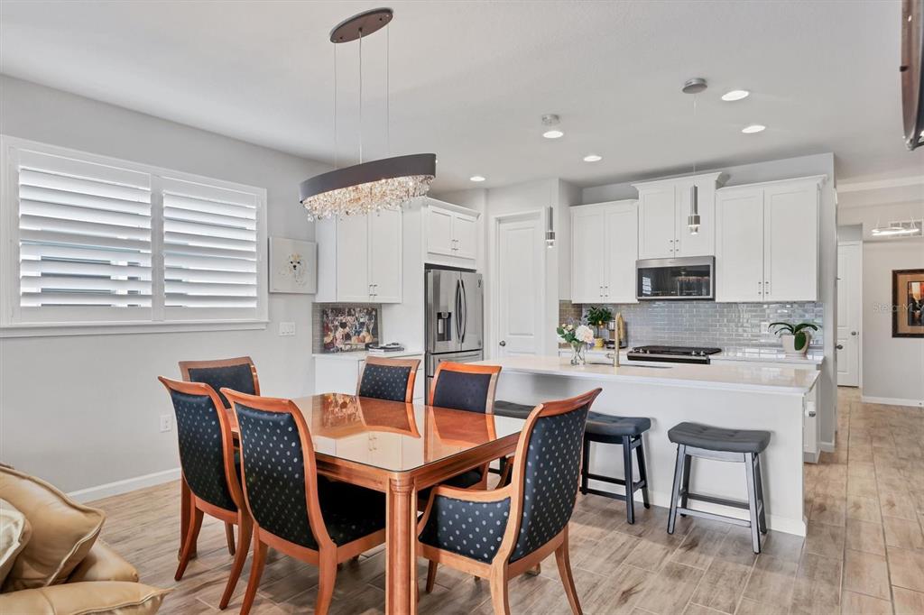 8733 Rain Song Road Sarasota, FL 34238 - Photo 8 of 39 a view of a dining room with furniture