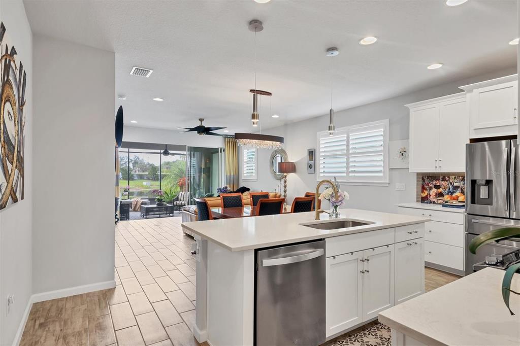 8733 Rain Song Road Sarasota, FL 34238 - Photo 10 of 39 a kitchen with sink refrigerator and window