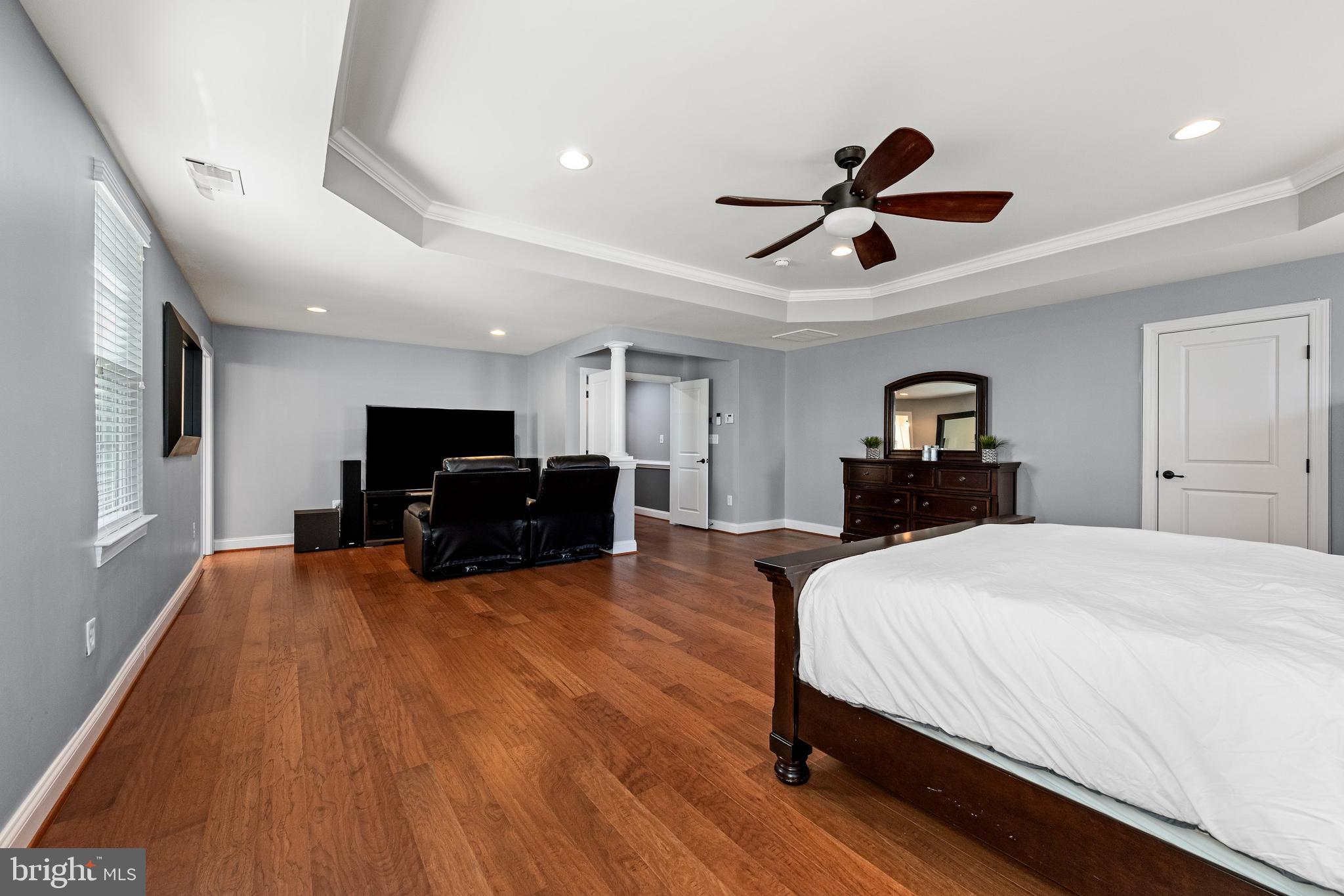 15511 Hillview Court Culpeper, VA 22701 - Photo 20 of 39 a spacious bedroom with a bed and a chandelier