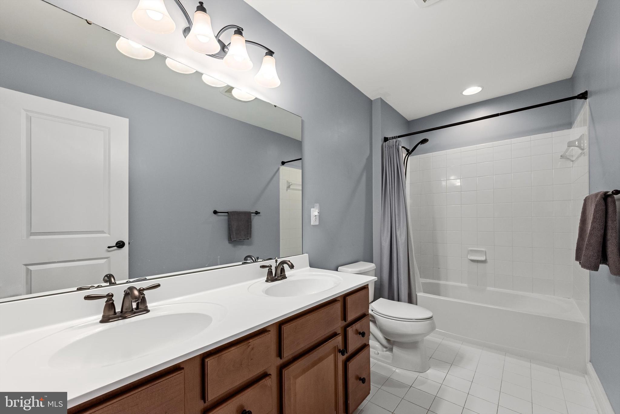 15511 Hillview Court Culpeper, VA 22701 - Photo 26 of 39 a bathroom with a double vanity sink mirror and toilet