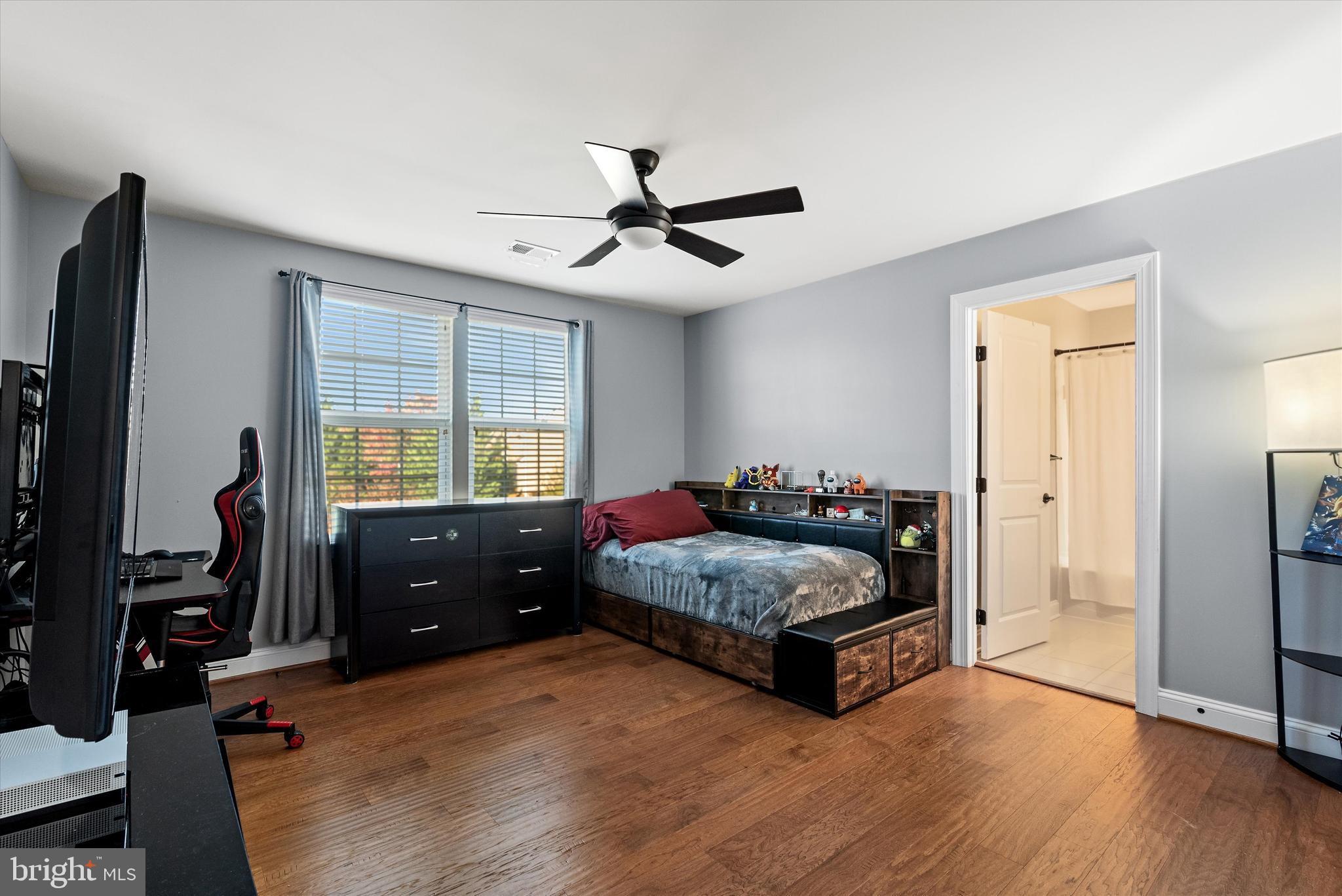 15511 Hillview Court Culpeper, VA 22701 - Photo 27 of 39 a living room with a bed furniture flat screen tv and a window