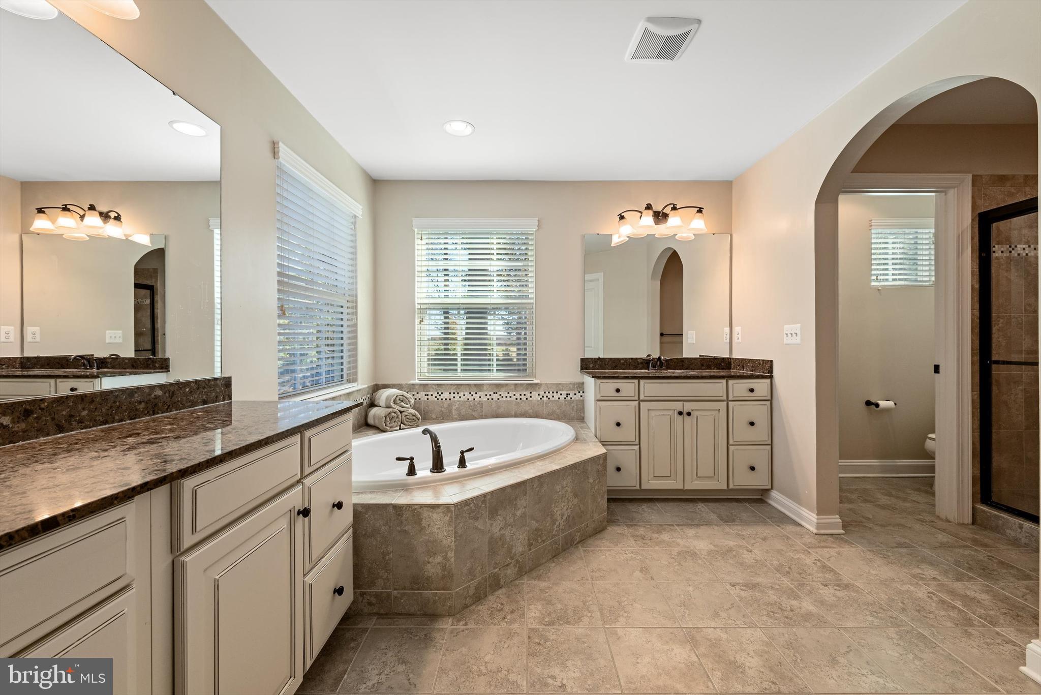 15511 Hillview Court Culpeper, VA 22701 - Photo 5 of 39 a large spacious bathroom with a large tub sink and mirror