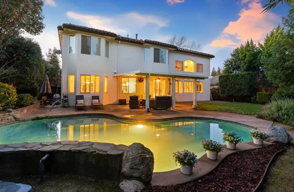 a view of a swimming pool with chairs