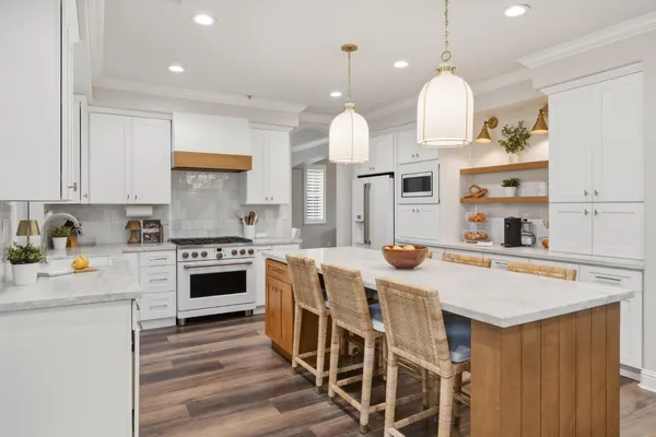 a kitchen with kitchen island a stove a center island and a stove