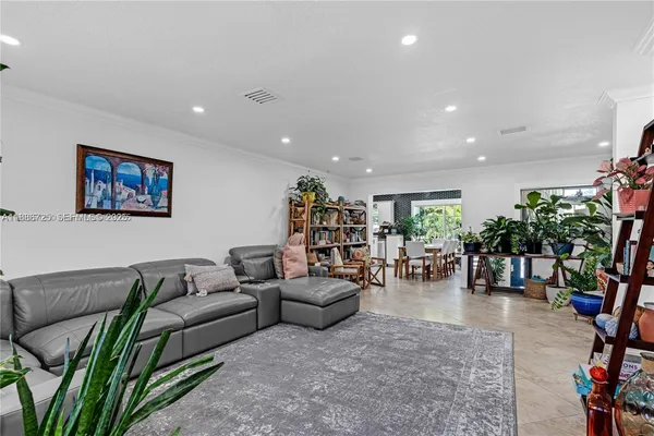 a living room with furniture and flowers