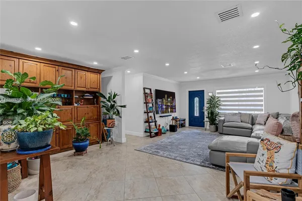 a living room with furniture and a potted plant