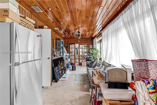 a living room with furniture a fireplace and a large window