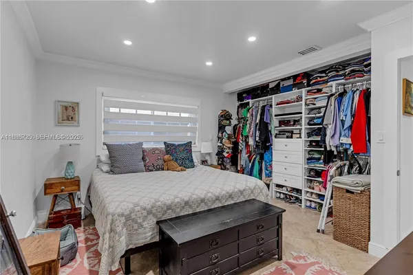 a bedroom with a bed a books bucket with a desk and chair
