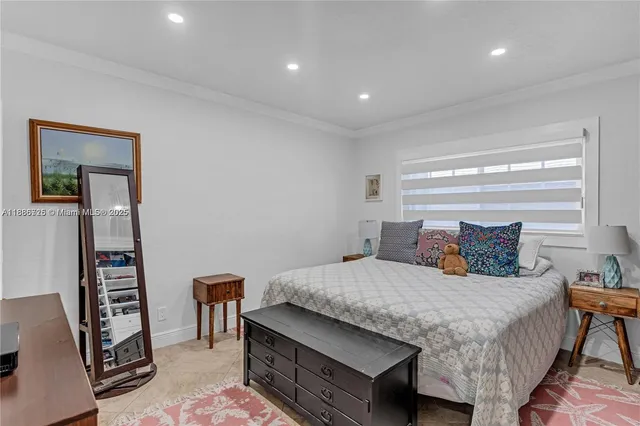 a bedroom with a bed a dresser and a bookshelf