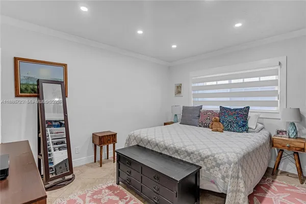 a bedroom with a bed a dresser and a bookshelf