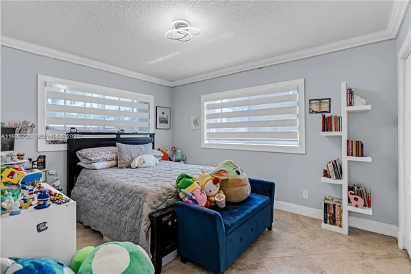 a bedroom with bed and a window