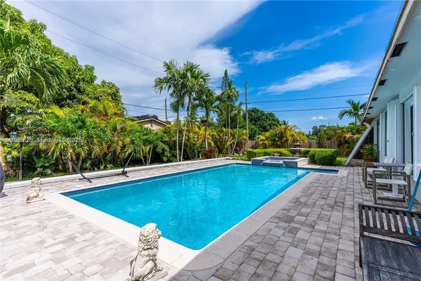 a view of a swimming pool with a lounge chairs