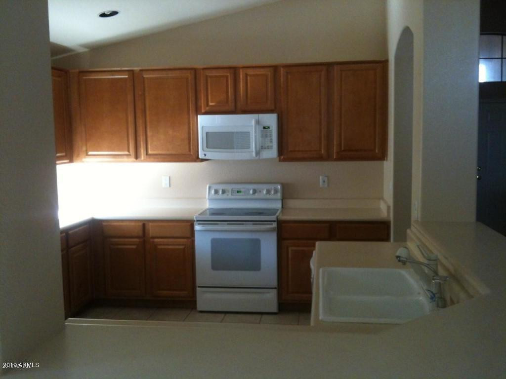 321 West Cardinal Way Chandler, AZ 85286 - Photo 2 of 7 a kitchen with granite countertop a sink and a stove top oven