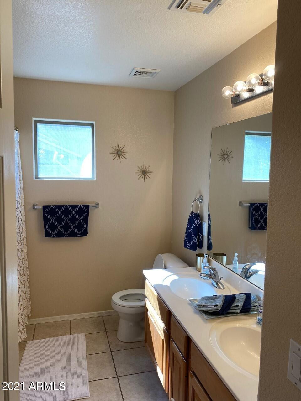 321 West Cardinal Way Chandler, AZ 85286 - Photo 7 of 7 a bathroom with a sink a toilet and mirror