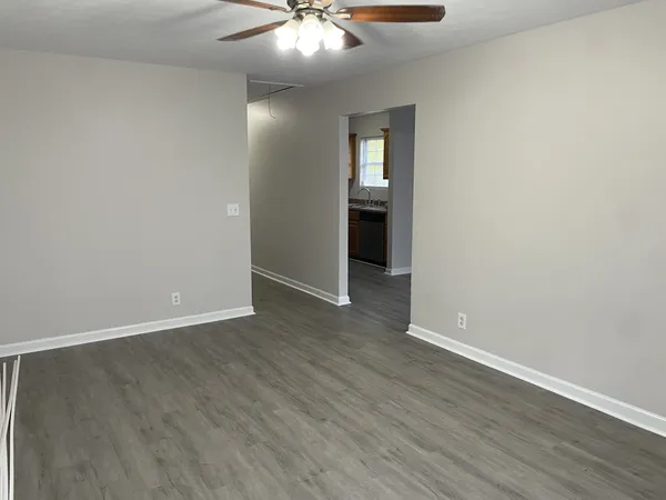 wooden floor in an empty room with a mirror