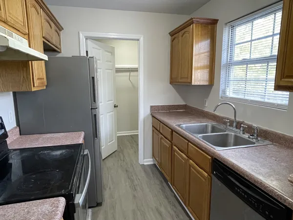 a kitchen with a sink stove and refrigerator