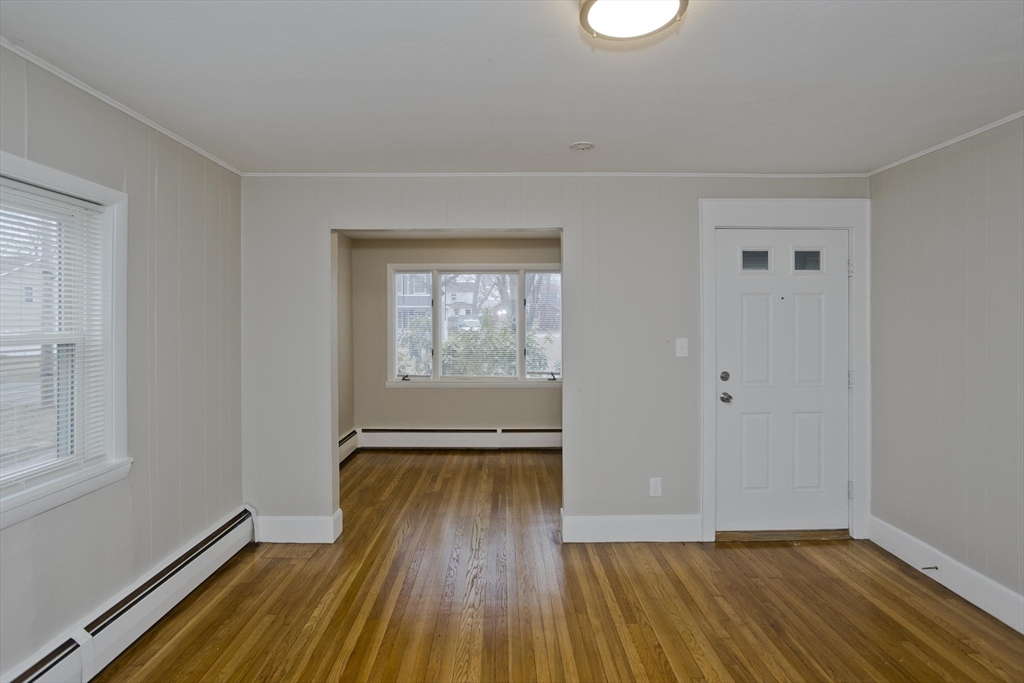 177 Marion Street Chicopee, MA 01013 - Photo 23 of 36 an empty room with wooden floor and windows