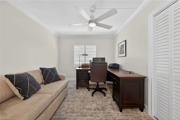 a livingroom with workspace and a couch