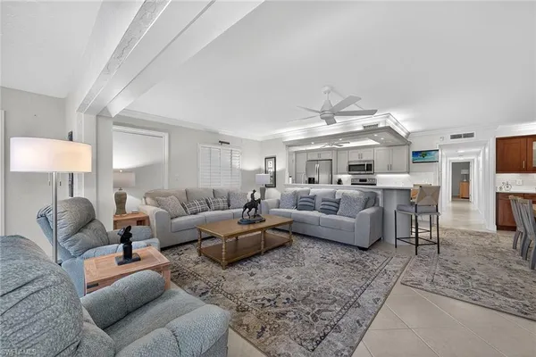 a living room with furniture and a chandelier