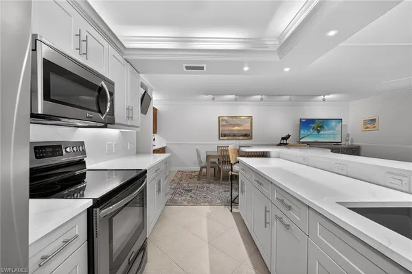 a kitchen with stainless steel appliances granite countertop a sink and a stove
