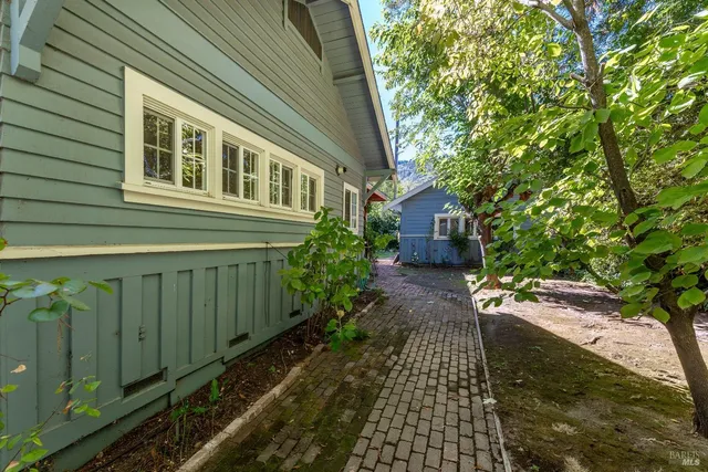 a view of a backyard with a plants and a table and chair