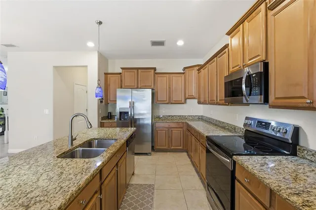 an empty room with wooden floor windows and entrance