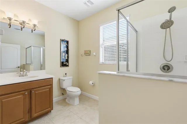a bathroom with a sink double vanity granite tub and a mirror
