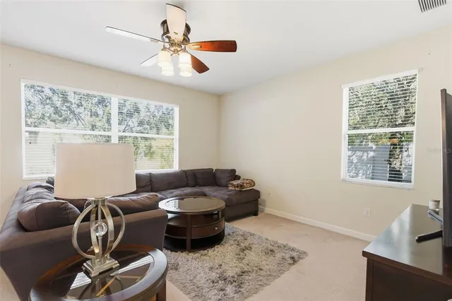 a kitchen with stainless steel appliances kitchen island granite countertop a table chairs and a refrigerator