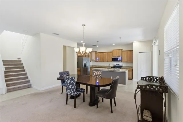 a kitchen with stainless steel appliances granite countertop a sink stove refrigerator and cabinets