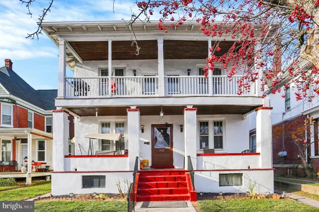 a front view of a building with a garden
