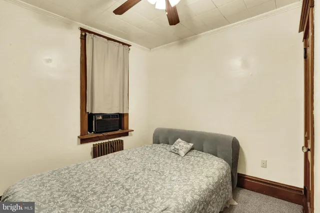 a room with a table chairs and a flat screen tv