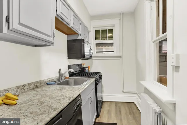 an empty room with wooden floor and a window
