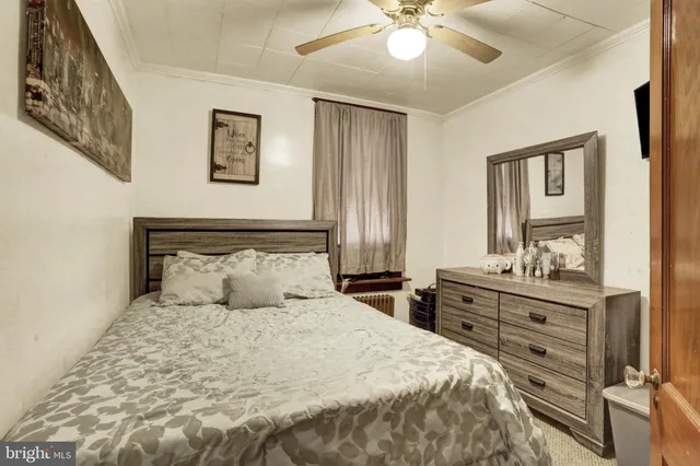 a bedroom with a bed and a television