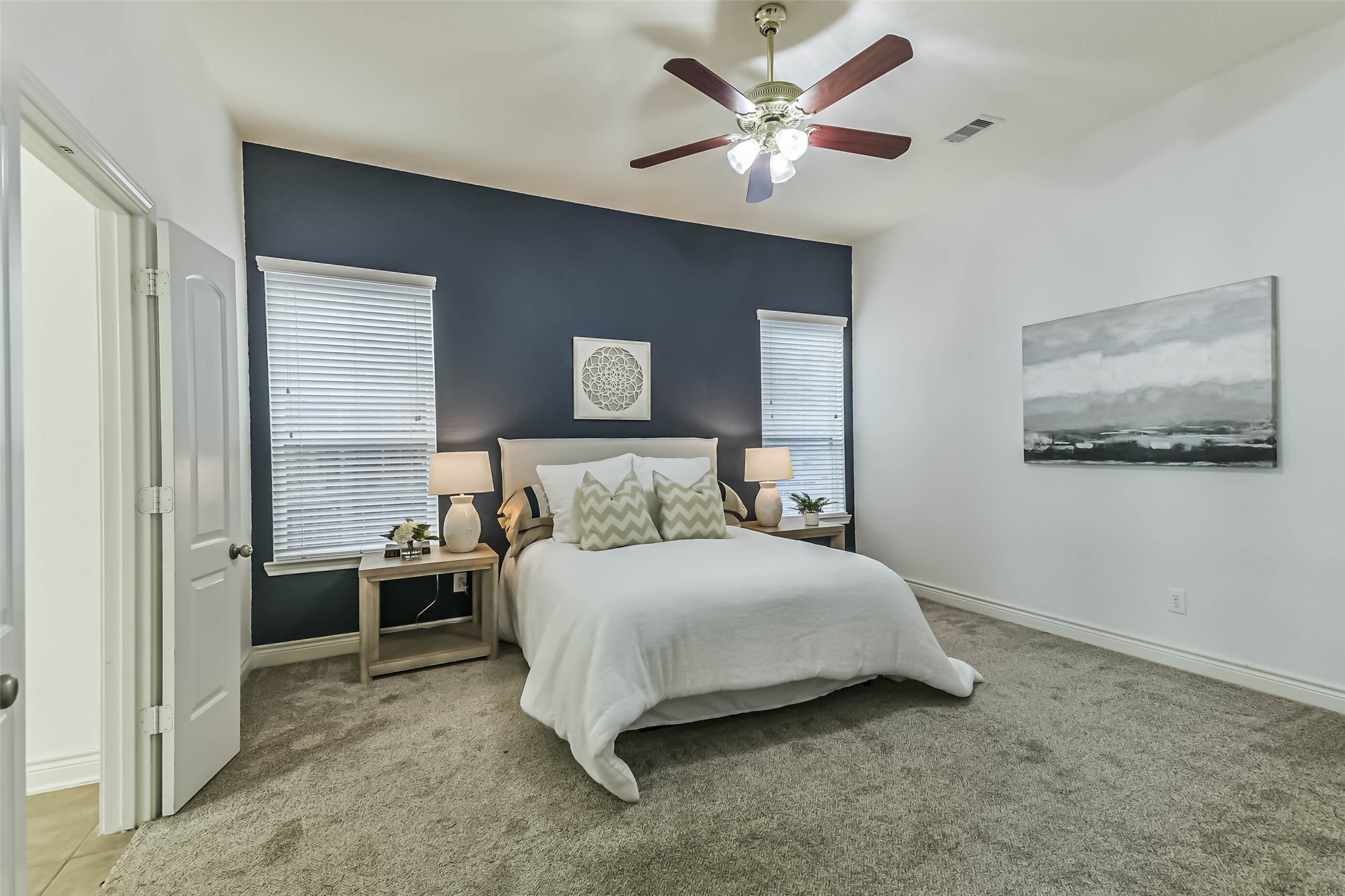 19022 Greenleaf Ridge Court Cypress, TX 77429 - Photo 23 of 47 a bedroom with a bed and a chandelier