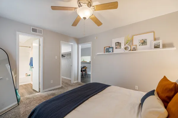 a bedroom with a bed and a chandelier