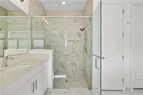 a bathroom with a sink a toilet and a shower