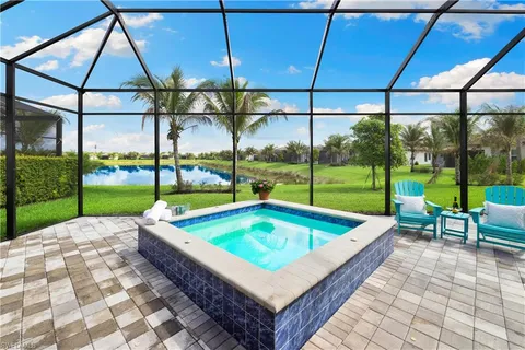 a view of swimming pool with outdoor seating and lake view