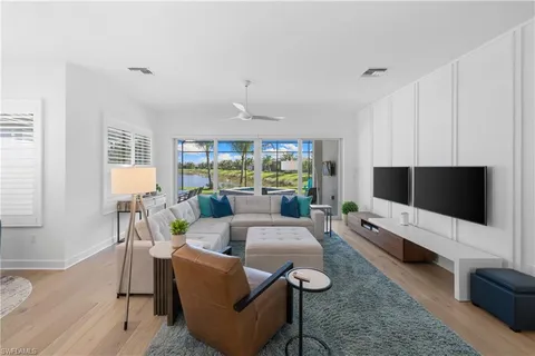 a kitchen with stainless steel appliances kitchen island granite countertop a stove a sink a refrigerator a microwave oven with a dining table and chairs