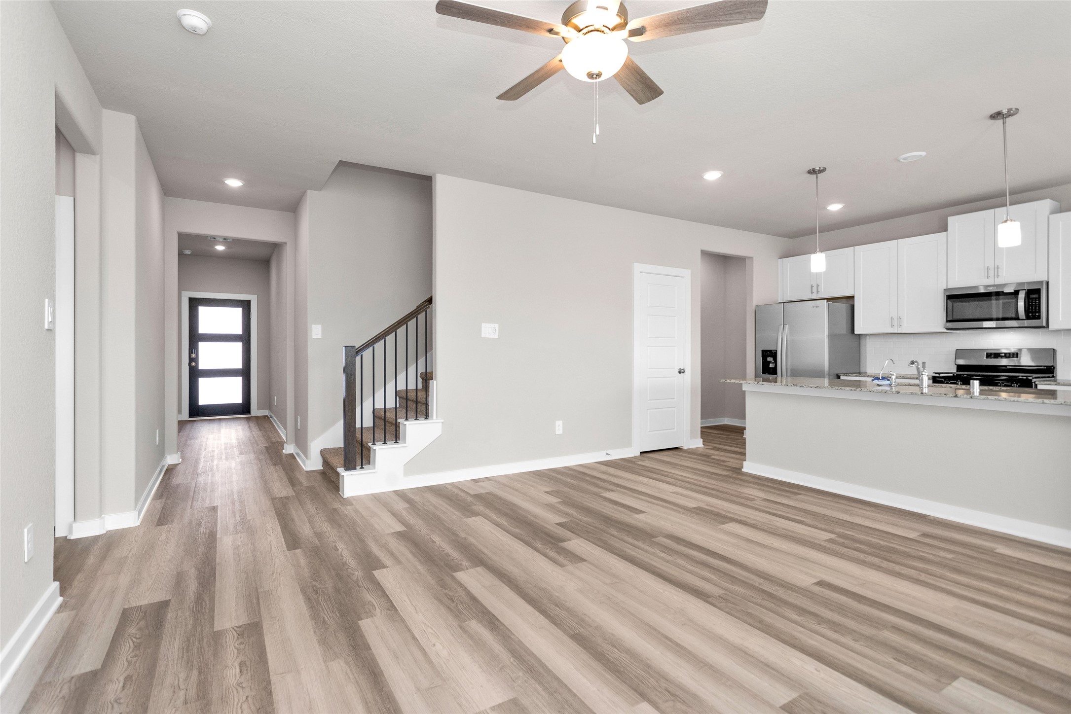 1406 Waggoner Rnch Trail Conroe, TX 77301 - Photo 12 of 43 a view of a kitchen with a stove cabinets and wooden floor