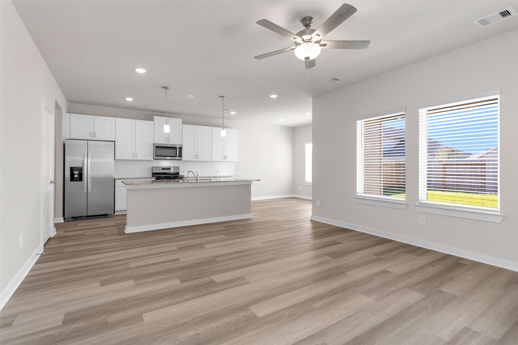 1406 Waggoner Rnch Trail Conroe, TX 77301 - Photo 13 of 43 a view of kitchen with refrigerator stove microwave and cabinets