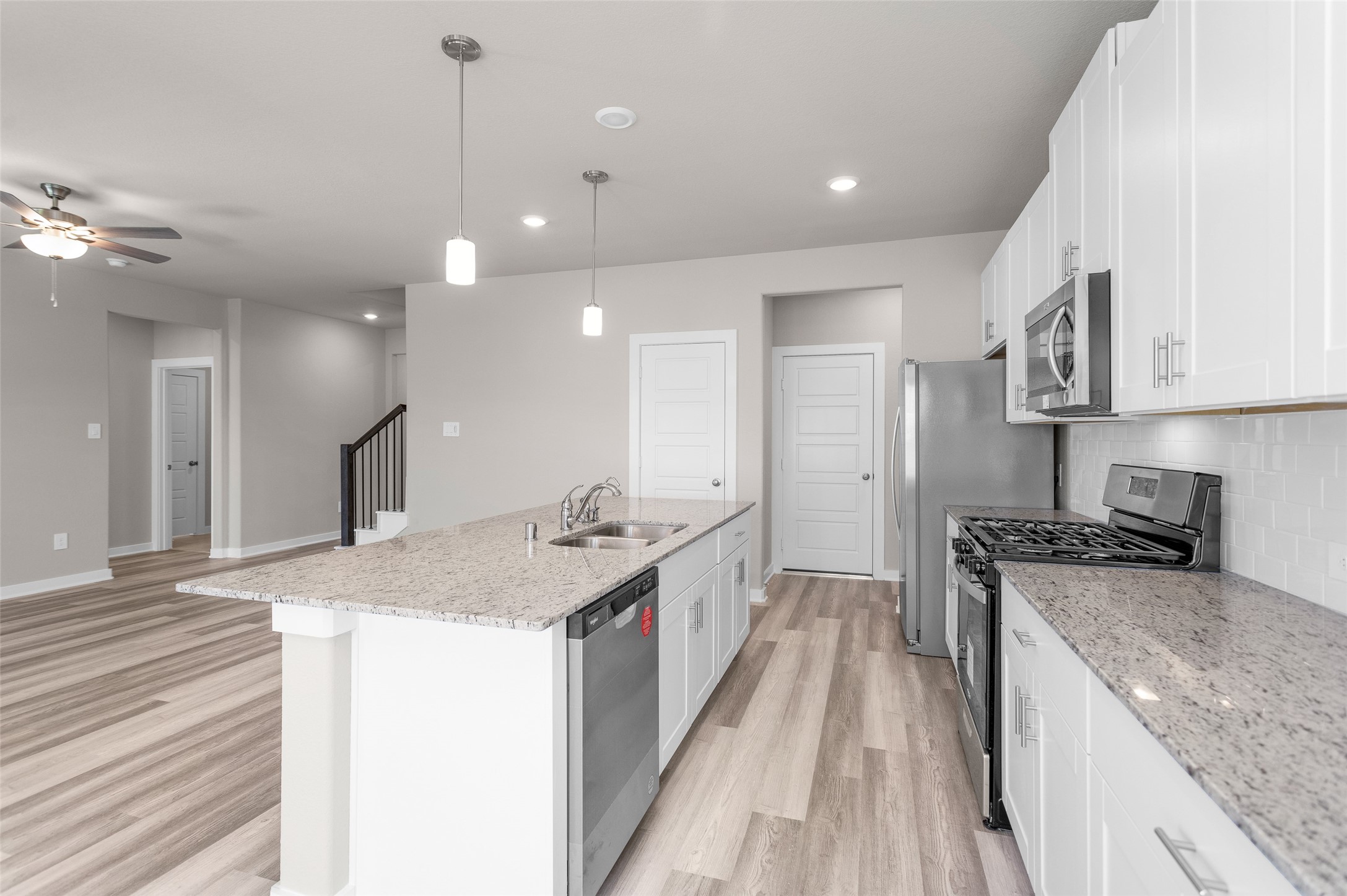 1406 Waggoner Rnch Trail Conroe, TX 77301 - Photo 15 of 43 a kitchen with a stove sink and refrigerator