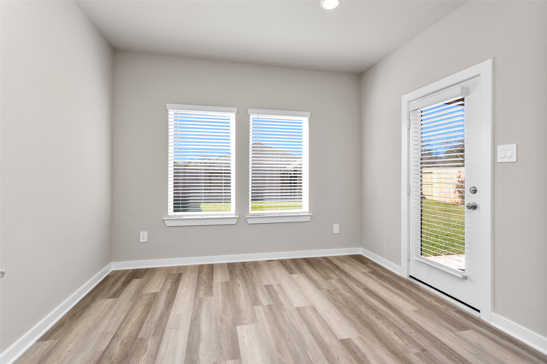 1406 Waggoner Rnch Trail Conroe, TX 77301 - Photo 18 of 43 a view of an empty room with wooden floor and a window