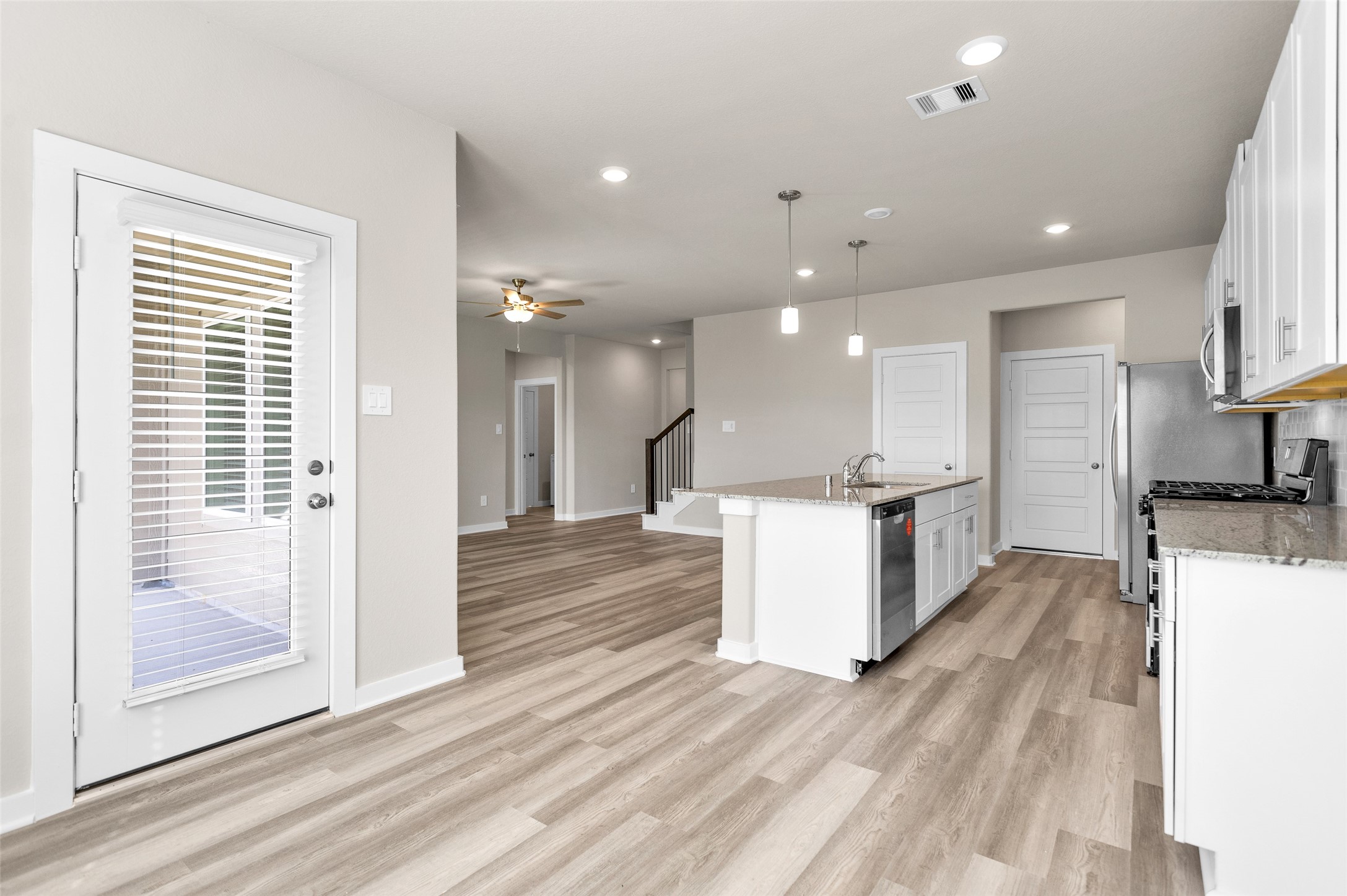 1406 Waggoner Rnch Trail Conroe, TX 77301 - Photo 19 of 43 a view of kitchen with kitchen island stainless steel appliances refrigerator stove microwave and cabinets