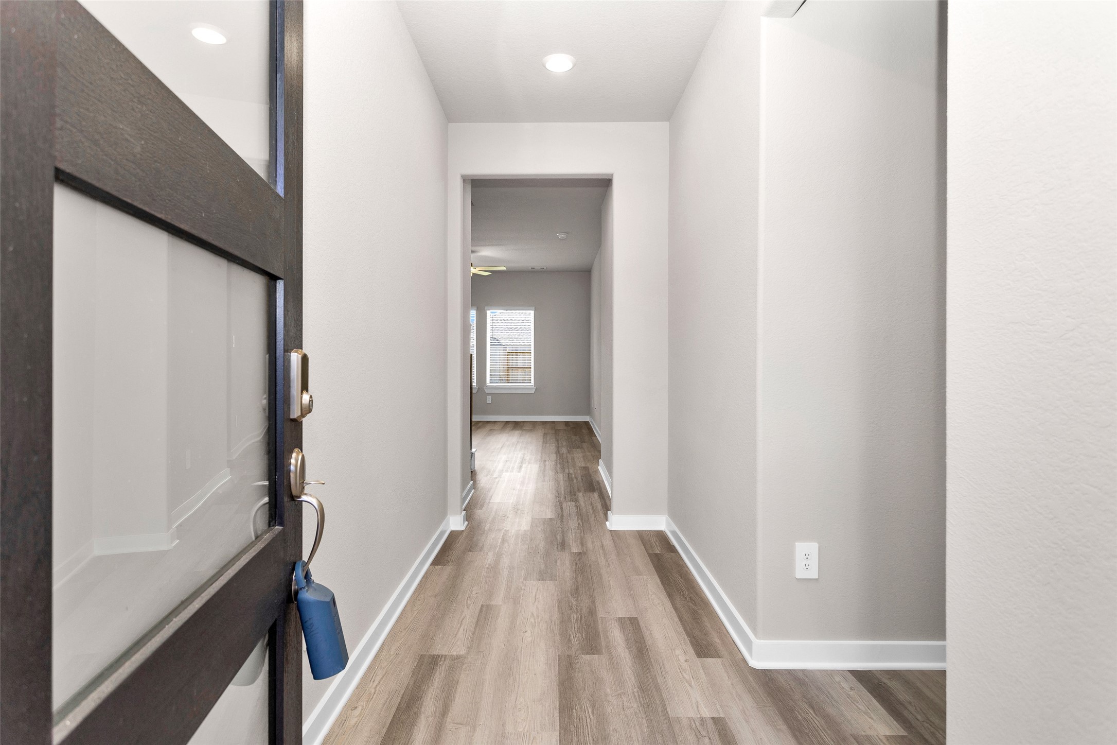1406 Waggoner Rnch Trail Conroe, TX 77301 - Photo 5 of 43 a view of a hallway with wooden floor and a bathroom