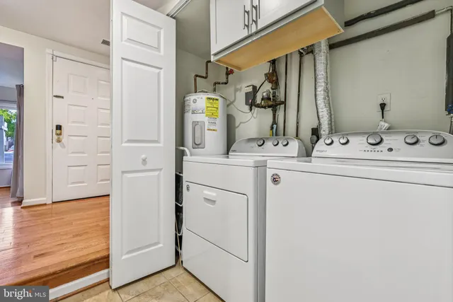 a bathroom with a granite countertop sink and a toilet