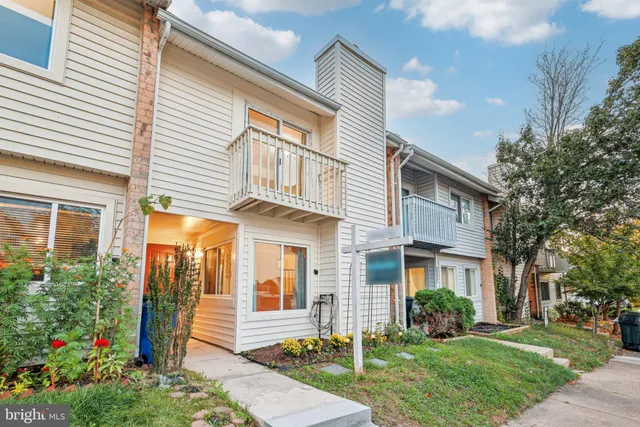 a view of an empty room with window and fire place