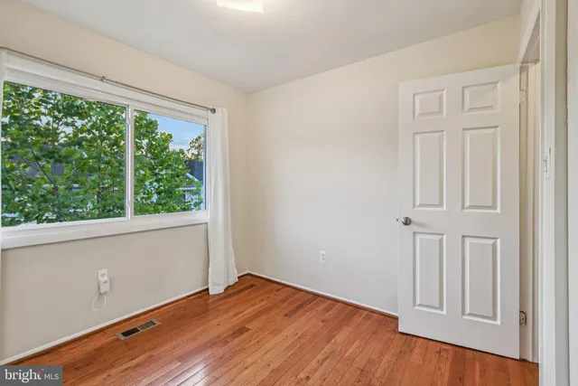 a bathroom with a toilet a sink a mirror and shower curtain