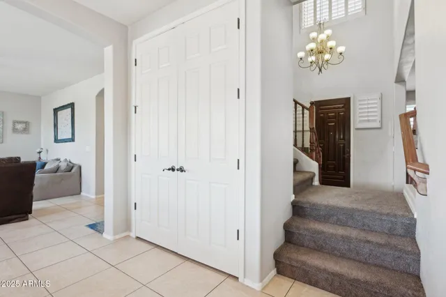 a view of a hallway to a livingroom with furniture